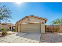 Beige house featuring a large two-car garage, desert landscaping, and a concrete driveway under a bright blue sky at 1268 S 238Th Ln, Buckeye, AZ 85326