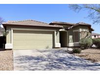 Charming single-story home featuring desert landscaping, a neutral color palette, and an attached two-car garage at 16234 W Shangri La Rd, Surprise, AZ 85379