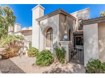 Charming two-story townhome with a gated front entrance and mature desert landscaping at 1718 S Longmore St # 116, Mesa, AZ 85202