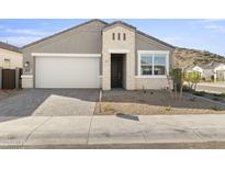 Charming single-Gathering home featuring a two-car garage, stone accents, and desert landscaping at 17801 W Mission Ln, Waddell, AZ 85355