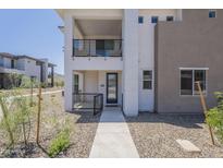 Modern two-story home features a balcony, black trim windows, and low maintenance desert landscaping at 2121 W Sonoran Desert Dr # 95, Phoenix, AZ 85085