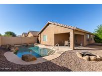 Backyard with in ground swimming pool, covered patio and desert landscaping at 2187 W Kristina Ave, Queen Creek, AZ 85144