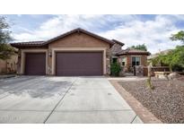 Charming single-story home with a spacious driveway and a well-maintained desert landscape at 26293 W Runion Ln, Buckeye, AZ 85396