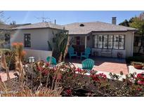 Inviting front yard with brick patio, outdoor seating, and lush landscaping, creating a cozy and charming curb appeal at 325 W Palm Ln, Phoenix, AZ 85003