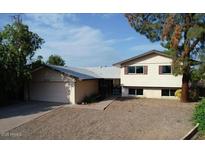 Traditional two story home with a large front yard and attached two car garage with concrete driveway at 4216 W Solano Dr, Phoenix, AZ 85019