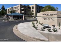 Gated entrance to Biltmore Terrace Condominiums with mature landscaping and security at 5132 N 31St Way # 127, Phoenix, AZ 85016