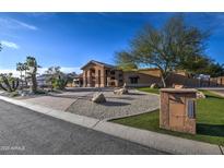 Stunning single-story home featuring a well-maintained yard with desert landscaping and a charming mailbox at 5332 W Misty Willow Ln, Glendale, AZ 85310