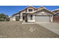 Charming two-story home with a well-manicured lawn and a classic tile roof, creating a welcoming curb appeal at 5618 W Blackhawk Dr, Glendale, AZ 85308