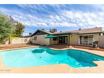 Inviting backyard pool perfect for relaxation and entertaining, with ample deck space and blue sky backdrop at 624 E Laguna Dr, Tempe, AZ 85282