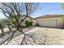 Attractive home exterior featuring a well-manicured yard and a two-car garage at 7705 E Doubletree Ranch Rd # 21, Scottsdale, AZ 85258