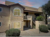 Attractive condo building with classic architecture, tiled roof, neutral stucco and well maintained landscaping at 9451 E Becker Ln # 2027, Scottsdale, AZ 85260