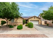 Charming single-story home featuring a two-car garage, desert landscaping, and a well-maintained lawn at 10414 W Windsor Ave, Avondale, AZ 85392