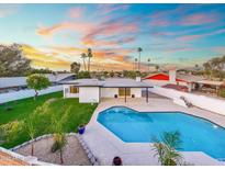 Inviting backyard pool and lush landscaping offers a serene outdoor living space at 1317 E Verlea Dr, Tempe, AZ 85282