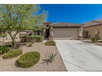Charming single-story home with a two-car garage, desert landscaping, and a welcoming front entrance at 17784 W Sandy Rd, Goodyear, AZ 85338