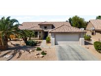 Charming home featuring low maintenance desert landscaping and a two-car garage at 18514 N Laguna Azul Ct, Surprise, AZ 85374