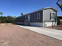 Charming single-story home with a well-maintained yard, concrete driveway, and crisp gray paint at 255 S 92Nd Pl, Mesa, AZ 85208