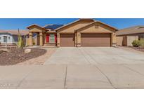 Charming single-Gathering home features a two-car garage, solar panels, desert landscaping, and a brick-paved walkway at 25536 W Primrose Ln, Buckeye, AZ 85326