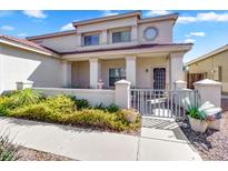 Home with an inviting front porch featuring stately columns, a decorative fountain, and a charming gated entrance at 8817 S 13Th Way, Phoenix, AZ 85042
