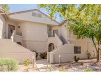 Inviting multi-story condo with a well maintained facade, mature landscaping, and convenient access to various units at 9555 E Raintree Dr # 1018, Scottsdale, AZ 85260