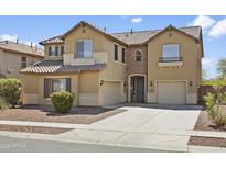 Charming two-story home with desert landscaping, attached two-car garage, and inviting curb appeal at 11959 W Vernon Ave, Avondale, AZ 85392