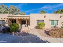 Charming single story home showcasing desert landscaping, shade trees and covered front porch entry at 14300 W Bell Rd # 58, Surprise, AZ 85374