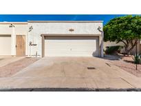 Front exterior of the home featuring a one car garage with neutral paint and a well kept yard at 2277 N Recker Rd # 6, Mesa, AZ 85215