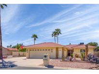Charming single-story home featuring a well-manicured desert landscape and a red tile roof under a sunny sky at 25850 S Foxglenn Dr, Sun Lakes, AZ 85248