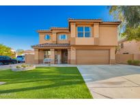 Two-story home showcasing an attractive facade, manicured lawn, and a welcoming covered porch at 3473 E Wyatt Way, Gilbert, AZ 85297
