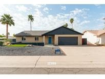 Charming single-story home with a brick facade, well-maintained landscaping, and a two-car garage at 8621 E Vista Dr, Scottsdale, AZ 85250