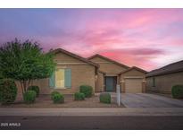 Charming single-story home with desert landscaping, a two-car garage and colorful sunset backdrop at 10528 W Crown King Rd, Tolleson, AZ 85353