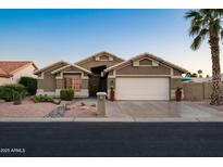 Charming single-story home with a two-car garage, desert landscaping, and a well-maintained front yard at 15149 W Vale Dr, Goodyear, AZ 85395