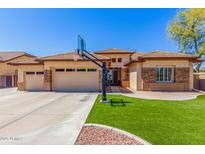 Attractive single-story home featuring a basketball hoop, paver patio, and a well-maintained front yard at 20540 N 86Th Ln, Peoria, AZ 85382