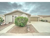 Charming single-story home featuring a stucco exterior, landscaped front yard, and attached two-car garage at 2101 S Meridian Rd # 99, Apache Junction, AZ 85120