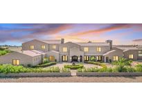 Elegant two-story home with a circular driveway, lush landscaping, and a private gated entrance at 2285 E Chandler Heights Rd, Chandler, AZ 85249