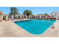 Enjoy community pool with ample space for swimming and relaxing on a sunny day at 2455 E Broadway Rd # 13, Mesa, AZ 85204