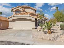 Charming home features a two-car garage, desert landscaping, and a tile roof at 2916 E Amber Ridge Way, Phoenix, AZ 85048