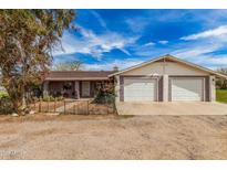 Charming single-story home with a two-car garage and desert landscaping at 3137 W Baseline Rd, Laveen, AZ 85339