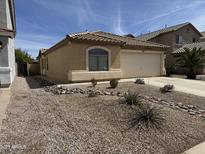 Charming single-story home with a well-maintained xeriscaped front yard and a two-car garage at 37959 N Luke Ln, San Tan Valley, AZ 85140