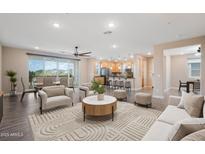 Open-concept living room showcasing modern furnishings and seamless flow to the kitchen and dining area at 5100 E Rancho Paloma E Dr # 1046, Cave Creek, AZ 85331