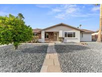 Charming single-story home with stone accents, a well-maintained yard, and a welcoming walkway at 6134 E Hannibal St, Mesa, AZ 85205