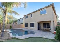 Backyard pool with palm trees, putting green and beautiful desert landscaping at 9009 S 57Th Dr, Laveen, AZ 85339