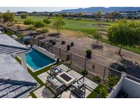 An inviting backyard with a pool, fire pit, and views of the golf course at 11344 N San Clemente St, Surprise, AZ 85388