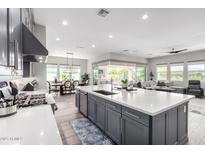 Open concept kitchen boasts a large island, stainless steel appliances, and seamless flow to living spaces at 11344 N San Clemente St, Surprise, AZ 85388