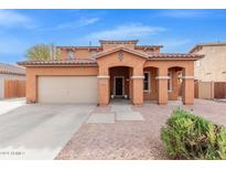 Charming two-story home with a neutral-colored exterior, tile roof, and well-manicured front yard at 1343 E Walnut Rd, Gilbert, AZ 85298