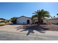 Charming single story home with a well maintained front yard and a two car garage at 2605 N Pleasant Dr, Chandler, AZ 85225