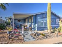 Charming blue home with covered patio and desert landscaping, plus a big saguaro cactus at 3104 E Broadway Rd # 212, Mesa, AZ 85204