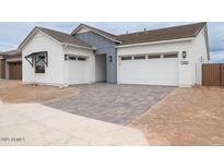 Charming single-Gathering home featuring a three-car garage and well-manicured, desert-style landscaping at 1246 E Penedes Dr, Gilbert, AZ 85298