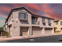 Charming multi-level townhome with private garages and a balcony, set against a vibrant sky at 1250 S Rialto -- # 47, Mesa, AZ 85209