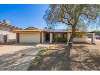 Charming single-story home with a two car garage, covered entry, desert landscaping, and mature shade tree at 14801 N 39Th Ave, Phoenix, AZ 85053