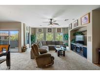 Bright living room featuring plush furniture, ceiling fan, and large windows offering serene outdoor views at 16525 E Avenue Of The Fountains Ave # 201, Fountain Hills, AZ 85268